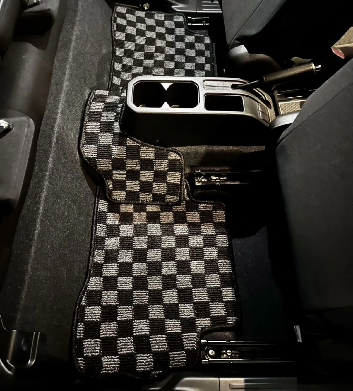 JDM Checkered car floor mats in a vehicle interior
