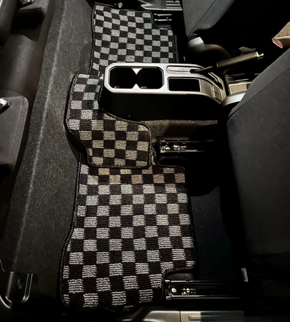 JDM Checkered car floor mats in a vehicle interior